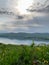 Great panoramic view. A clean mountain lake in the midst of majestic mountains in a haze of fog. On the Sunset. Copy