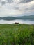 Great panoramic view. A clean mountain lake in the midst of majestic mountains in a haze of fog. On the Sunset. Copy