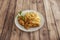 Great plate of crispy Kentucky-style chicken with a portion of French fries and a sprig of fresh parsley