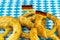 Great pretzel with salt Oktoberfest symbol, a set of beer snacks against the background of the Munich pattern