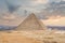 The great pyramid of Cheops in Cairo. The Egyptian pyramids of Giza on the background of Cairo. Miracle of light. Architectural