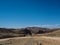 Great rock mountain texture lining landscape of Namib desert unique geography with splitting stone ground road and desert plant