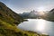 Great Saint Bernard Pass, Switzerland. Summer mountain flowers and Sunset over the Lake
