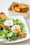 Great Salade Lyonnaise, French classic salad. Eggs, bacon, toasts.