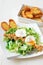 Great Salade Lyonnaise, French classic salad. Eggs, bacon, toasts.