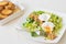 Great Salade Lyonnaise, French classic salad. Eggs, bacon, toasts.