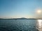 Great seascape with the land at the horizon at sunset