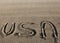 Great text USA United States of America on the sand of the beach