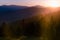 Great view of colorful sunrise in the mountains backlight glow against the sunlight with sun flare and bokeh. Concept of the awake