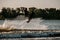 Great view of dynamic guy holding rope and jumping high with wakeboard over water