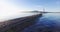 Great view of family on the spit: father plays with his son, mother stands near