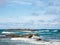 Great view of the sea, a little island and a boat on a beautiful windy day at Condado beach, San Juan, Puerto Rico