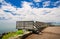 Great view of wooden comfortable deck near the lake against blue cloudy sky background