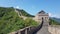 Great Wall of China in a green forest landscape at Mutianyu in Huairou District near Beijing, China.