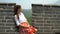 Great Wall China travel- Woman sitting on the famous tourist attraction