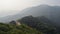 The great wall protecting the frontier through the mountains surrounded by dense forest, Mutianyu section, Beijing, China