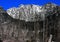 Great wall of rocks rising behind the forest