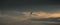 Great white egret flying in the distance sky evening silhouetted photograph, tropical climate, and warmth of the evening sun.