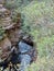 Greaves Creek flowing past a cliff on the Grand Canyon Walk Blackheath in the Blue Mountains Australia.