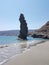 Greece andros island beach called tis grias to pidima, rock high in the sea