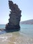 Greece andros island beach called tis grias to pidima, rock high in the sea