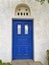 Greece, blue door with local technique marble bass-relief