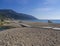 Greece, corfu, Agios Georgios, september 23, 2018: View on sea shore wooden promenade with sand beach, green river stream and rela