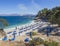 Greece, corfu, Kassiopi september 28, 2018: View of Bataria white sand beach with blue sunbeds and tourist people at
