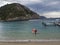 Greece, Corfu, Paleokastritsa, september 26, 2018: red motorboat and tourist boats parking at pier at Paleokastritsa bay