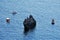 Greece, Corfu - small boats around a rock on the coast of Corfu in the summer time