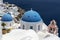 Greece. Cyclades Islands - Santorini Thira. Oia town with typical Cycladic architecture - painted blue cupolas and white walls