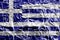 Greece flag depicted in paint colors on shiny crumpled aluminium foil closeup. Textured banner on rough background