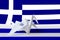 Greece flag depicted on paper origami crane wing. Handmade arts concept