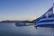 The greece flag flies in Sami harbor on the island of Kefalonia