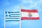 Greece and French Polynesia two flags on flagpoles and blue sky