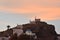 Greece, the island of Ios. Three chapels atop a hill at sunset.