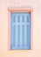 Greece, Kea island. Traditional wooden window shutters blue pastel color on pink painted wall in capital city of Ioulis