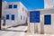 Greece, Kimolos island. Information road signs, traditional whitewashed buildings at Chora