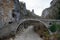 Greece Kokkorou Noutsou arched stone bridge over Voidomatis dry river Zagorohoria Epirus