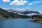 Greece Lake Aoos Springs Epirus. Aoos river artificial Lake, snowy Pindus mountain peak background