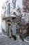 Greece, Milos island, Chora town, Plaka. Stonewall peeled aged building. Melos Cyclades. Vertical