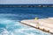 Greece, Naxos harbor destination Cyclades islands. View of corner of jetty and stone breakwater