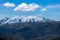 Greece Pindos mountain range. Snowy peak of Pindus misty mountain, blue sky background