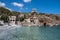 Greece. Rocky beach, moored boat in calm sea, Mani Laconia, Peloponnese crystal clear water