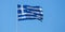 Greece sign symbol. Greek national official flag on flagpole waving in the wind, clear blue sky