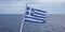 Greece sign symbol of leading shipping power in the world. Greek waving flag on flagpole over sea