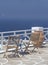 Greece, Sikinos. Wooden chairs and a blue table.o unwind