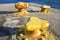 Greece, Sikinos. Yellow painted metal bollarfds at the harbor.