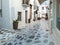 Greece Tinos island, Chora town. Cyclades architecture, outdoors cafe, cobblestone alley