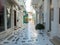 Greece Tinos island, Chora town. Cyclades, souvenir shop, outdoors cafe, paved alley